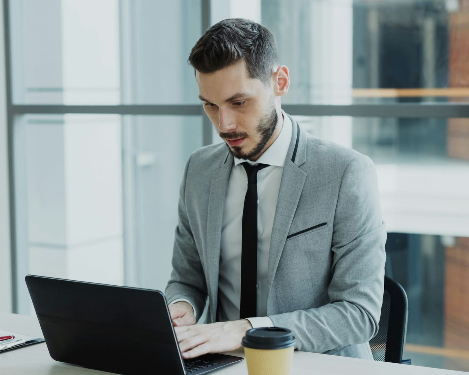 Outsourced accountant working on a client's bookkeeping in a modern office
