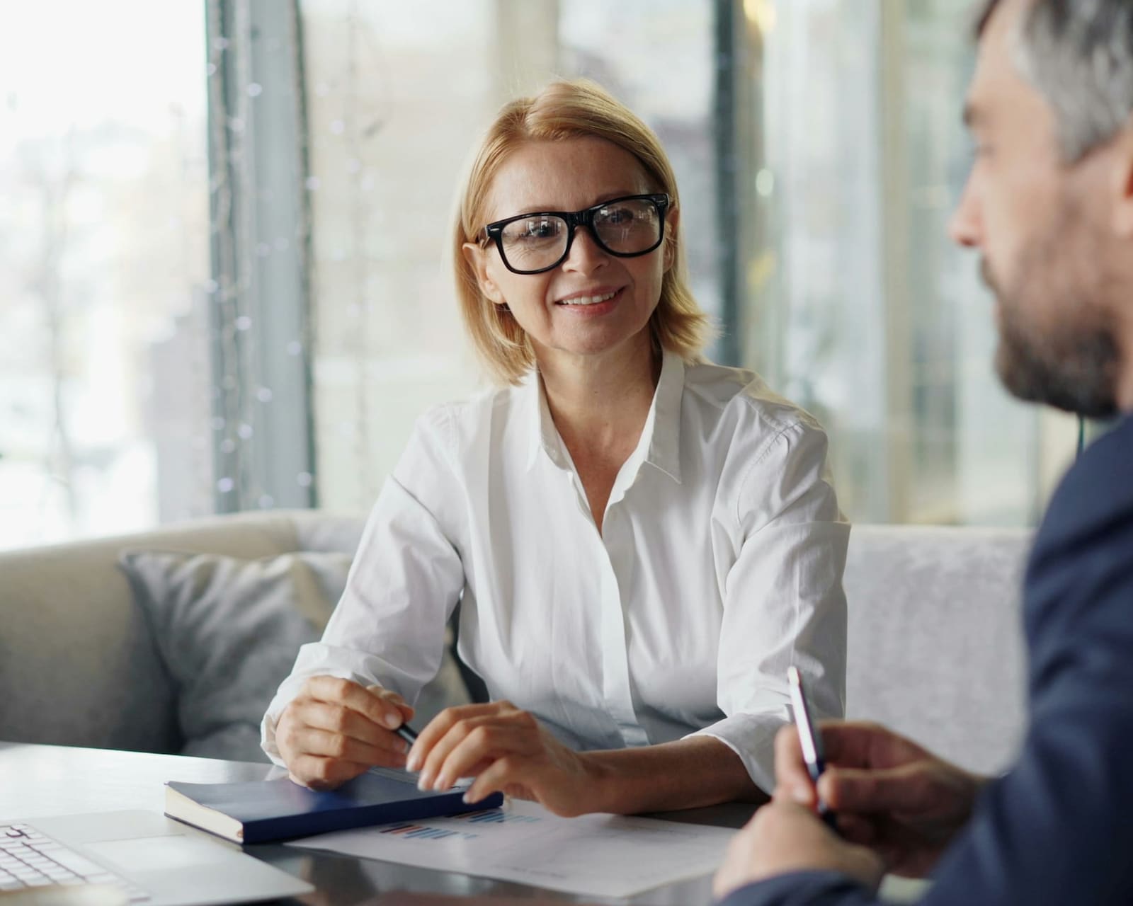 Financial advisor discussing forecasts with a business owner