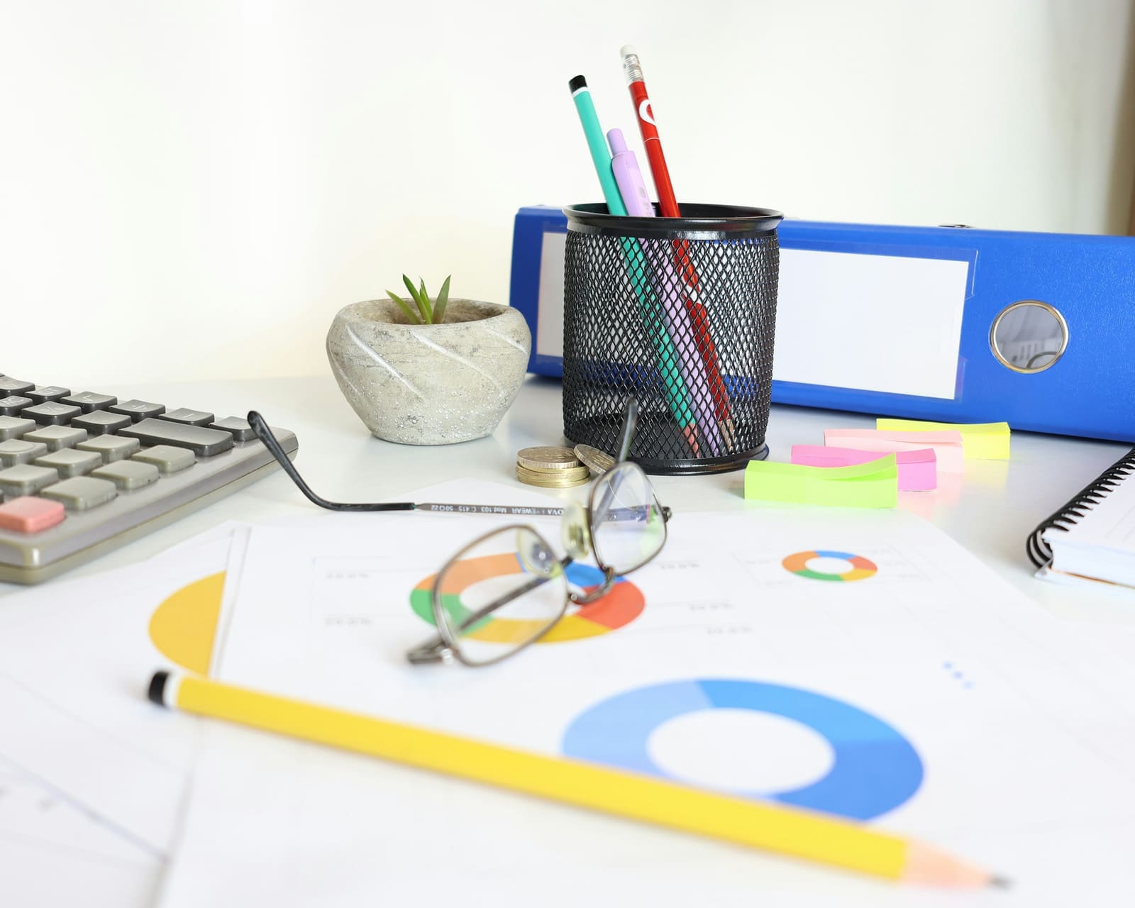 Organised desk with ledgers, calculator and reports after a bookkeeping clean-up
